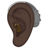 ear with hearing aid: dark skin tone